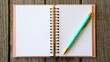 © Stock Shop - Blank pink notebook with teal pen on wooden table