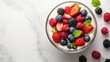 © pinporn manosri - Fresh and Juicy Mixed Berries in Glass Bowl with Mint Leaves on Marble Surface, Perfect for Healthy Snacks or Desserts, Colorful and Vibrant Display
