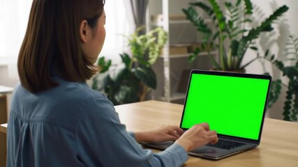 8k wallpaper featuring a woman working on laptop with vibrant green screen, ideal for creative projects, web design, and digital marketing.
