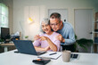 © Freedomz - Senior Asian Couple Enjoying Retirement Planning Online Together at Home Using Laptop Computer Searching for Investment Ideas and Financial Security