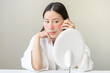 © KMPZZZ - Dermatology, scratch asian young woman looking at mirror, expression worry and itch, itchy allergy or allergic sensitive reaction, red spot or rash on her face. Beauty care from skin problem treatment