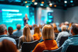 © perfectlab - Focused woman listening to business presentation at modern conference event