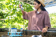 © KL 1981 - Agricultural students collect soil samples with test tubes and note for soil analysis in agricultural laboratory for farm science project. Smart agriculture experiment by young team.