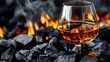 © ANDRI - Brandy or cognac in a glass with ice on charcoal