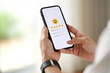 © Muhammad Hridoy - Person using smartphone to give five star rating and positive feedback