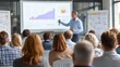 © NITAYA - speaker presenting project plan with graph poster, indoor seminar