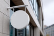 © Emanuel - Blank round signboard mockup displayed outside a shop entrance
