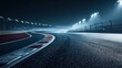 © PTM Motorsports - An empty Formula 1 track illuminated by bright floodlights at night, showcasing the sleek pavement and dramatic curves typical of racing circuits.
