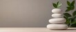 © Nongkran - Serene Stone Stacking with Fresh Leaf Symbolizing Balance and Harmony in Minimalist Decor