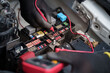 © bank_jay - Car Fuse Box Electrical Testing with Multimeter.Technician Checking Automotive Fuses.