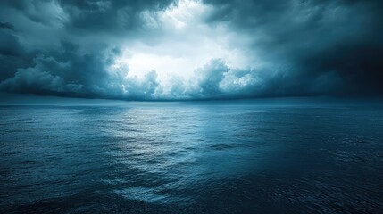 a vast expanse of ocean under a dramatic sky filled with dark clouds and a hint of light breaking th