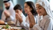 © Farid - A family gathers for a meal and prayer.