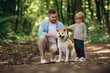 © standret - Father with son and dog are in the forest