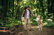© standret - Doing the tricks by using stick. Man tourist is with his dog in the forest