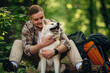 © standret - Owner of the pet is happy, playing with him. Man tourist is with his dog in the forest