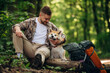 © standret - Break time, sitting. Man tourist is with his dog in the forest