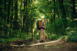 © standret - Male tourist is with backpack in the forest