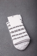 funny odd socks for geek, developer or programmer with binary 01 code and blank label on grey backgr