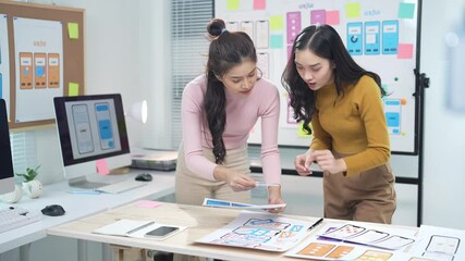 two ui/ux designers discussing mobile app development