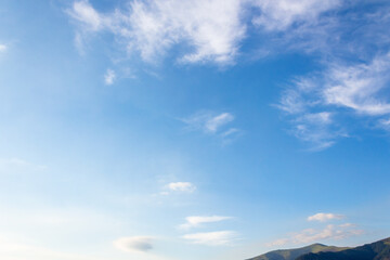 Wall Mural - nature backdrop with blue sky and white fluffy clouds in morning light. bright and sunny weather forecast background