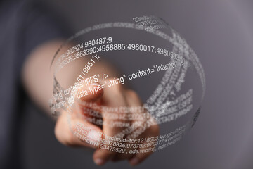 close-up of a hand interacting with a transparent sphere of digital code, representing data and tech