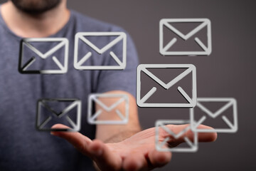 A man's hand displays multiple email icons, symbolizing efficient inbox management and communication.