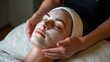 © Newleks - Beautician gently applying a moisturizing face mask to a relaxed client during a soothing spa treatment, enhancing skin health and promoting deep relaxation for ultimate wellbeing