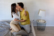 © we.bond.creations - Romantic couple sharing a tender moment, kissing passionately on their bed in a contemporary bedroom setting