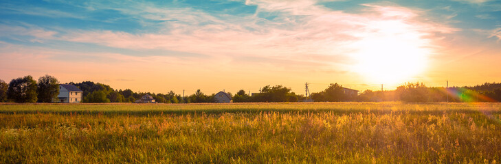 Wall Mural - view of a wheat field with beautiful sunset sky. panorama. horizontal banner