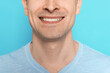 © New Africa - Smiling man after shaving on light blue background, closeup