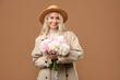 © New Africa - Happy woman with bouquet of beautiful peonies on brown background