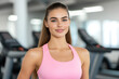 © pavlofox - Smiling woman in fitness attire at modern gym during workout session