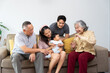 © Prot - A multigenerational family gathers together, sharing warmth and love as they celebrate a special family moment with newborn. Their care strengthen bond between generations, embracing positive emotions