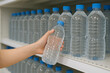 © INHYE GAL - Choosing Bottled Water at the Store