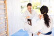 © JackF - Two women in kimono sparring together in gym during karate training