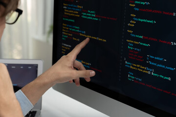 IT developer selecting by point on coding online software development information on pc comparing with laptop screen of new code program's update version firmware overall system project. Pecuniary.