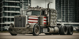 Zardzewiała ciężarówka z amerykańską flagą na masce, stojąca na tle nowoczesnych budynków. Klasyczny pojazd z elementami retro i militarnymi.