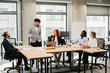© dsheremeta - Business team discussing new project during meeting in modern office