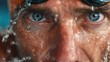 © ngstock - Hydration Awareness Intense close-up of a swimmer's face with water droplets and determined expression.