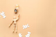 © Pixel-Shot - Wooden mannequin with light bulb and puzzle pieces on beige background. Logic concept