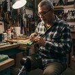 © Yaqeen - Craftsman at Work Concentrated Artisan Creating Detail Piece in Workshop Setting