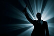 © Pukan - A silhouette of a man in a suit holding a trophy triumphantly against a backdrop of radiant light beams.