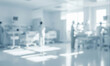 © al-sultan - Blurred hospital room with medical equipment and personnel in a bright setting.