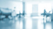 © al-sultan - Blurred hospital interior with beds and bright light creating a soft background.