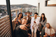 © Jacob Lund - Friends enjoying an evening gathering on a rooftop with drinks and laughter