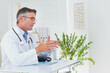 © WavebreakMediaMicro - Mature adult male doctor gesturing while explaining diagnosis at desk with stethoscope, copy space