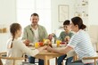 © New Africa - Family praying together before dinner at table indoors