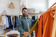 © ReeldealHD images - Man Examining Yellow Shirt in Clothing Store