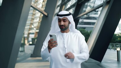 arab man using smartphone in modern city