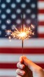© decorator - Sparkler Burning Hand American Flag Golden Glow